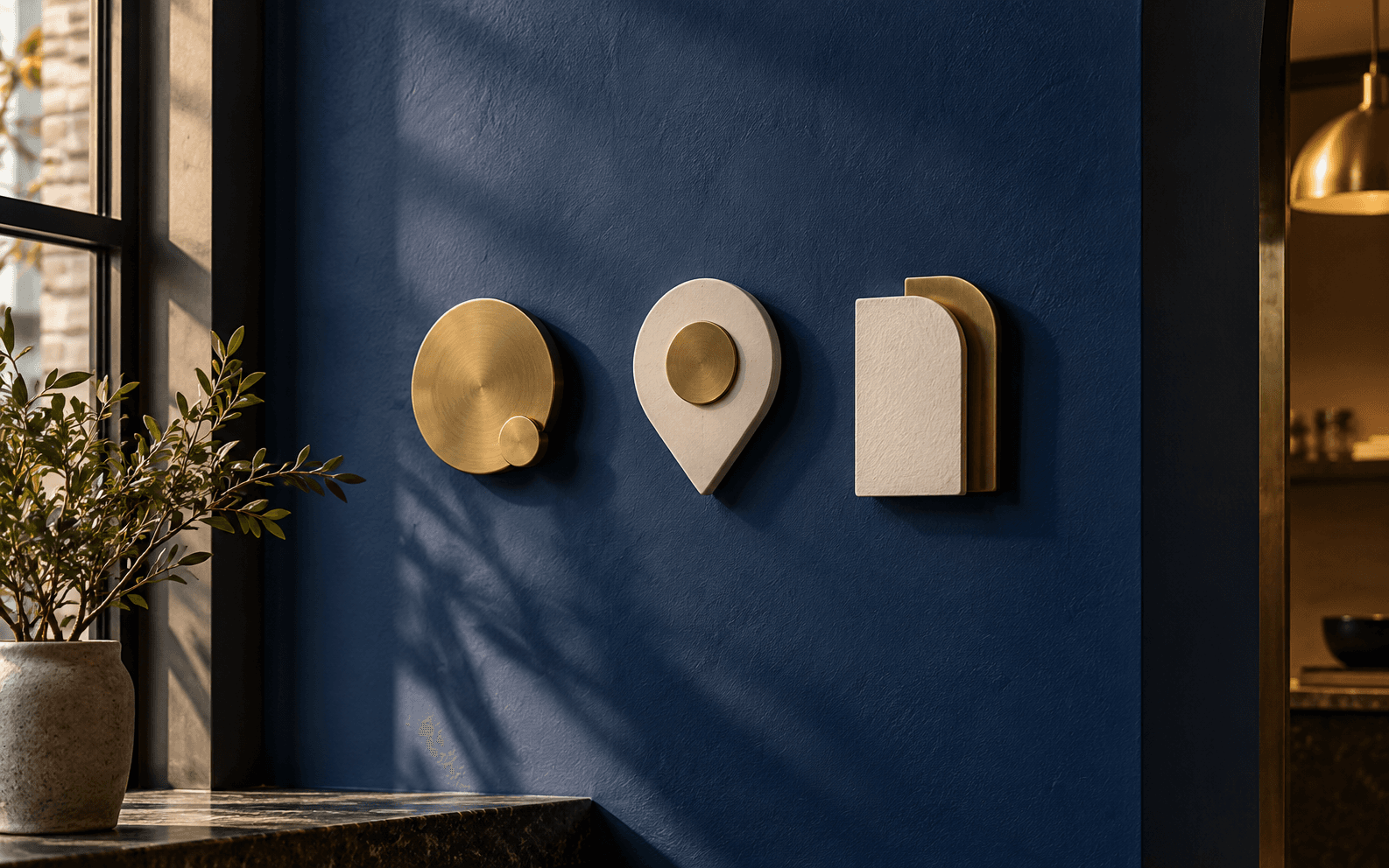 Three distinct blank brass and paper markers are mounted on a deep blue interior wall.